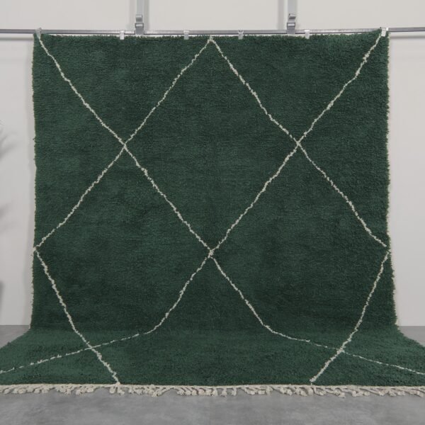 Handmade Moroccan rug in solid dark green, woven from 100% natural lamb wool by Berber artisans, featuring an optional trellis-style Beni Ourain pattern for a rich, earthy interior accent.