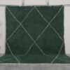 Handmade Moroccan rug in solid dark green, woven from 100% natural lamb wool by Berber artisans, featuring an optional trellis-style Beni Ourain pattern for a rich, earthy interior accent.