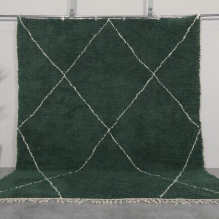 Handmade Moroccan rug in solid dark green, woven from 100% natural lamb wool by Berber artisans, featuring an optional trellis-style Beni Ourain pattern for a rich, earthy interior accent.