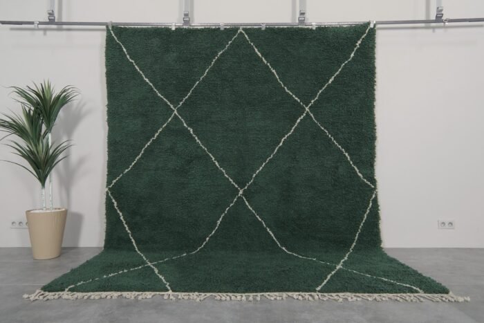 Handmade Moroccan rug in solid dark green, woven from 100% natural lamb wool by Berber artisans, featuring an optional trellis-style Beni Ourain pattern for a rich, earthy interior accent.