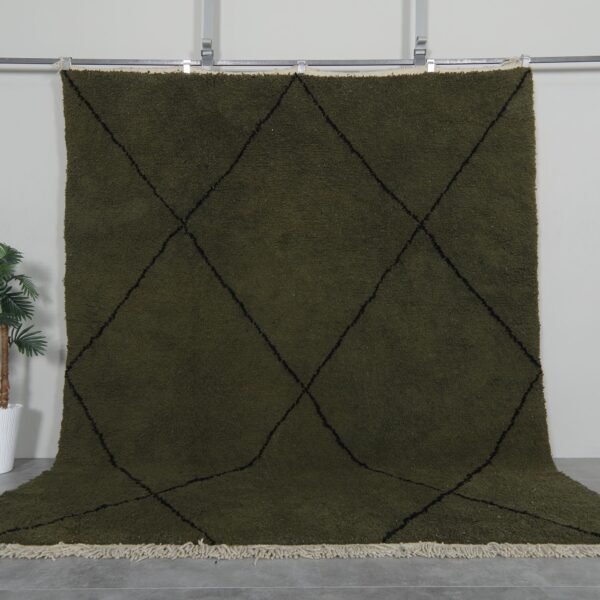 Handmade Moroccan rug with deep dark green base and bold black trellis pattern, crafted from 100% natural lamb wool by Berber artisans using traditional Beni Ourain weaving.