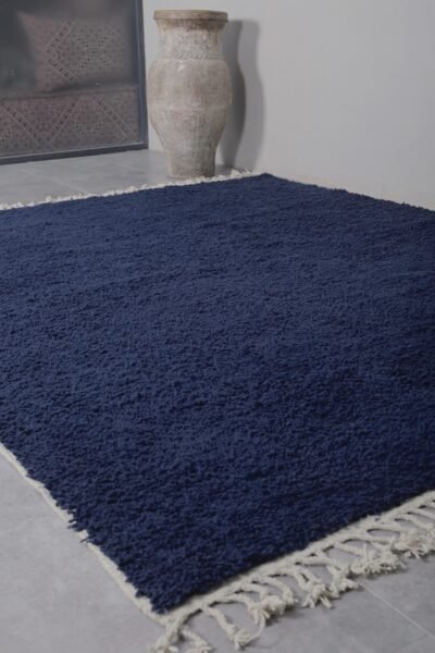 Hand-knotted wool fibers of the cobalt blue Moroccan rug, emphasizing the artisanal quality and plush texture created by Berber women weavers.