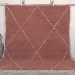 Handmade Moroccan rug featuring a rich chestnut brown base with an elegant ivory trellis pattern, crafted by Berber artisans using 100% genuine lamb wool in the traditional Beni Ourain style.