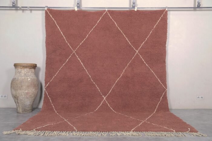 Handmade Moroccan rug featuring a rich chestnut brown base with an elegant ivory trellis pattern, crafted by Berber artisans using 100% genuine lamb wool in the traditional Beni Ourain style.
