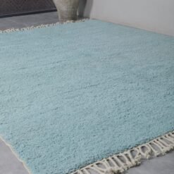 flat lay of a solid turquoise Beni Ourain rug, handwoven in Morocco using natural wool, ideal for bold, modern, or coastal interiors.