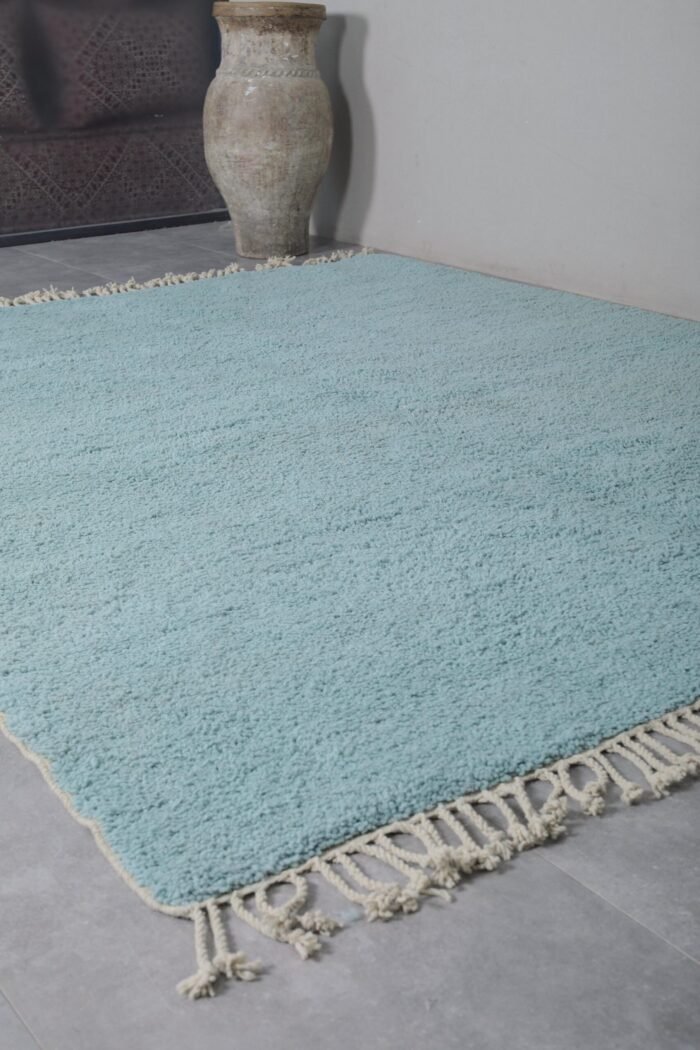 flat lay of a solid turquoise Beni Ourain rug, handwoven in Morocco using natural wool, ideal for bold, modern, or coastal interiors.