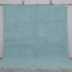 handmade turquoise Moroccan rug showing clean edge finishes, thick wool texture, and the rich color inspired by Mediterranean waters.