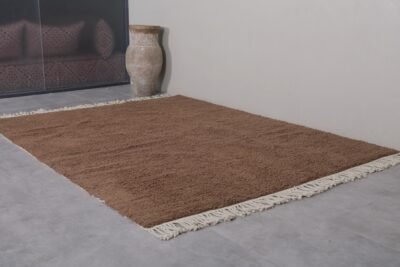 solid brown Moroccan rug, showcasing traditional weaving technique and soft wool pile made for comfort and durability.
