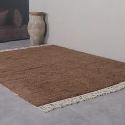 solid brown Moroccan rug, showcasing traditional weaving technique and soft wool pile made for comfort and durability.