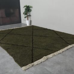 custom-sized dark green and black Moroccan rug, emphasizing the soft wool pile and striking trellis design.