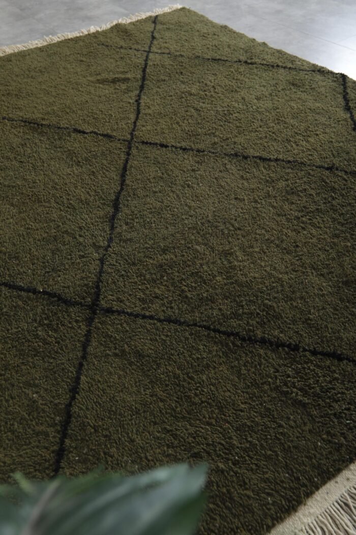 handmade Berber rug in deep green with black trellis pattern, highlighting fine weaving and natural lamb wool fibers.