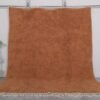 Authentic handmade Moroccan rug in warm rust color, crafted with soft natural wool and traditional Berber Beni Ourain patterns.