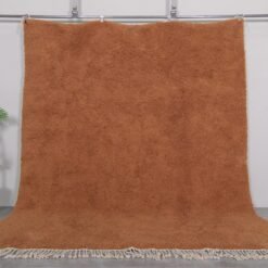 Authentic handmade Moroccan rug in warm rust color, crafted with soft natural wool and traditional Berber Beni Ourain patterns.