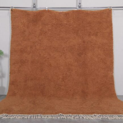 Authentic handmade Moroccan rug in warm rust color, crafted with soft natural wool and traditional Berber Beni Ourain patterns.
