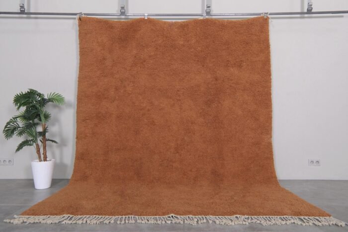 Authentic handmade Moroccan rug in warm rust color, crafted with soft natural wool and traditional Berber Beni Ourain patterns.