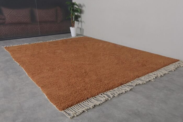 rustic Moroccan wool rug in deep rust hue, featuring classic Beni Ourain tribal designs.