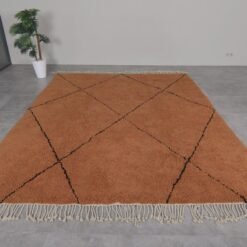 Moroccan wool rug in rust with black trellis design, showing quality craftsmanship and thick pile.