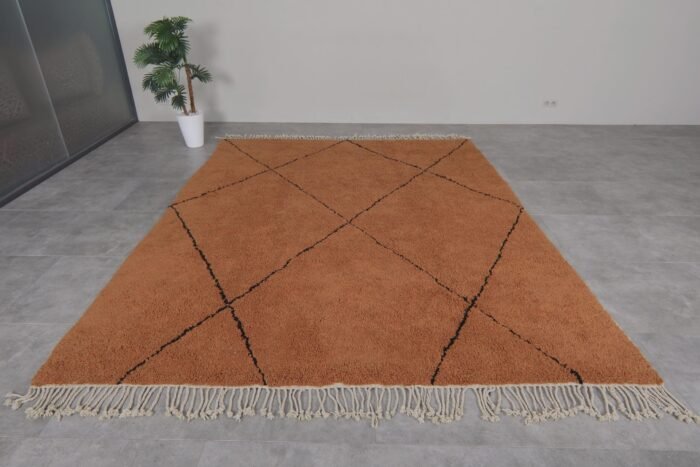 Moroccan wool rug in rust with black trellis design, showing quality craftsmanship and thick pile.