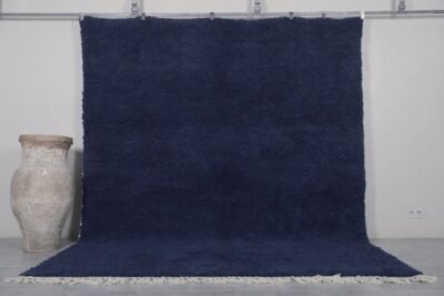 Authentic handmade Moroccan cobalt blue Beni Ourain rug crafted from 100% natural wool by Berber artisans. This vibrant solid blue rug features a thick, plush pile and traditional hand-knotted weaving, perfect for living rooms, bedrooms, or modern boho interiors.