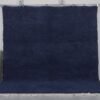 Authentic handmade Moroccan cobalt blue Beni Ourain rug crafted from 100% natural wool by Berber artisans. This vibrant solid blue rug features a thick, plush pile and traditional hand-knotted weaving, perfect for living rooms, bedrooms, or modern boho interiors.
