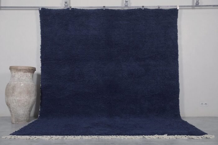 Authentic handmade Moroccan cobalt blue Beni Ourain rug crafted from 100% natural wool by Berber artisans. This vibrant solid blue rug features a thick, plush pile and traditional hand-knotted weaving, perfect for living rooms, bedrooms, or modern boho interiors.