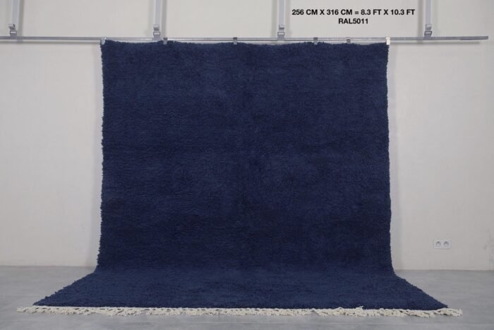 Moroccan cobalt blue wool rug, highlighting its hand-knotted pile and authentic Berber weaving from the Atlas Mountains.