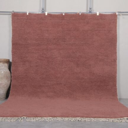Handmade Moroccan rust brown Beni Ourain rug crafted with 100% natural lamb wool, featuring a rich, earthy solid color and a plush shag texture, perfect for adding warmth and elegance to modern or rustic interiors.