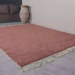 solid rust brown Moroccan wool rug, emphasizing the thick, plush texture and classic plain design, suitable for a variety of home decor styles.