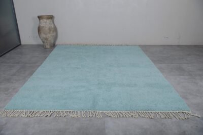 Turquoise Moroccan Beni Ourain rug highlighting its hand-knotted wool texture, earthy Berber craftsmanship, and vibrant design.