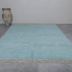 Turquoise Moroccan Beni Ourain rug highlighting its hand-knotted wool texture, earthy Berber craftsmanship, and vibrant design.