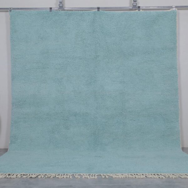 Handmade Moroccan Beni Ourain rug in vibrant turquoise, crafted from 100% natural wool by Berber artisans. A bold, luxurious wool area rug perfect for boho, coastal, or modern interiors.