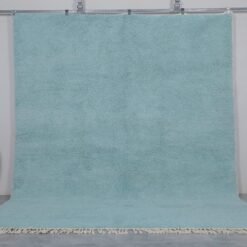 Handmade Moroccan Beni Ourain rug in vibrant turquoise, crafted from 100% natural wool by Berber artisans. A bold, luxurious wool area rug perfect for boho, coastal, or modern interiors.