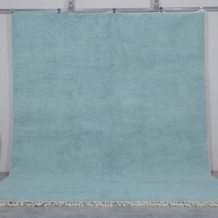 Handmade Moroccan Beni Ourain rug in vibrant turquoise, crafted from 100% natural wool by Berber artisans. A bold, luxurious wool area rug perfect for boho, coastal, or modern interiors.