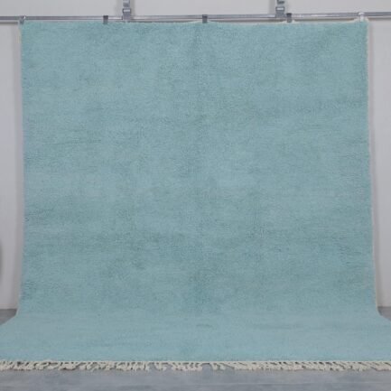 Handmade Moroccan Beni Ourain rug in vibrant turquoise, crafted from 100% natural wool by Berber artisans. A bold, luxurious wool area rug perfect for boho, coastal, or modern interiors.