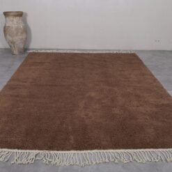 custom brown Beni Ourain rug, highlighting hand-knotting craftsmanship and natural material in a warm earthy tone.