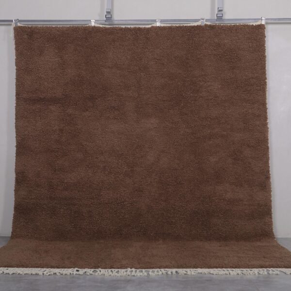 Authentic handmade Moroccan Beni Ourain rug in solid brown, woven from 100% lamb’s wool by Berber artisans. A timeless wool area rug for earthy, modern, or rustic interiors.
