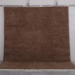 Authentic handmade Moroccan Beni Ourain rug in solid brown, woven from 100% lamb’s wool by Berber artisans. A timeless wool area rug for earthy, modern, or rustic interiors.