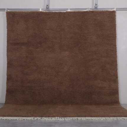 Authentic handmade Moroccan Beni Ourain rug in solid brown, woven from 100% lamb’s wool by Berber artisans. A timeless wool area rug for earthy, modern, or rustic interiors.