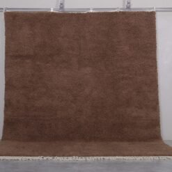 handmade brown Moroccan wool rug, showing clean edges, thick texture, and the richness of natural wool fibers.