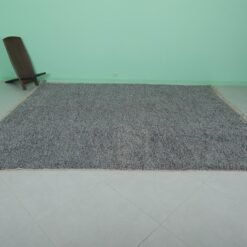 handmade Moroccan gray wool rug featuring Beni Ourain tribal motifs, showcasing the soft, plush texture and the high-quality natural wool material used by Moroccan artisans.