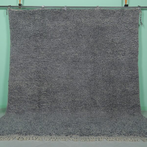 Handmade Moroccan gray wool rug with traditional Beni Ourain tribal patterns, crafted by skilled Berber artisans from 100% natural lamb wool, featuring a soft, durable pile perfect for living rooms and bedrooms with modern or rustic decor