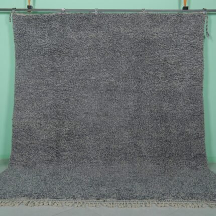 Handmade Moroccan gray wool rug with traditional Beni Ourain tribal patterns, crafted by skilled Berber artisans from 100% natural lamb wool, featuring a soft, durable pile perfect for living rooms and bedrooms with modern or rustic decor