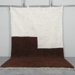 ivory and brown Moroccan wool rug showcasing minimalist design and thick wool pile texture.