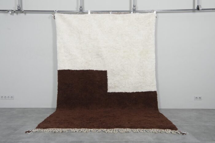ivory and brown Moroccan wool rug showcasing minimalist design and thick wool pile texture.