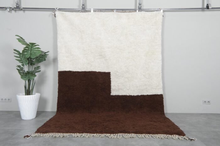 Handwoven Moroccan Beni Ourain rug in contemporary ivory and brown colors, crafted from 100% natural lamb wool by Berber artisans.