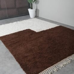 ivory and brown Moroccan Beni Ourain rug with symmetrical pattern and soft wool detail.