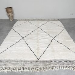 hand-knotted Moroccan wool rug in ivory with black geometric trellis design, showcasing thick plush wool texture.