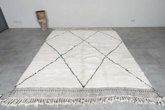 hand-knotted Moroccan wool rug in ivory with black geometric trellis design, showcasing thick plush wool texture.