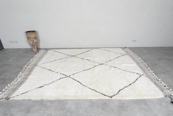 Moroccan wool rug in ivory and black trellis design, illustrating quality weaving and thickness.