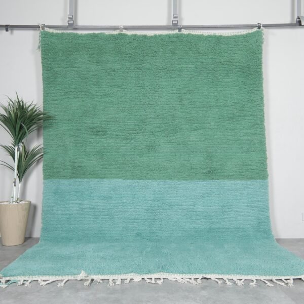 Minimalist Moroccan rug hand-knotted in forest green and soft aqua blue, made from 100% wool by Berber artisans.